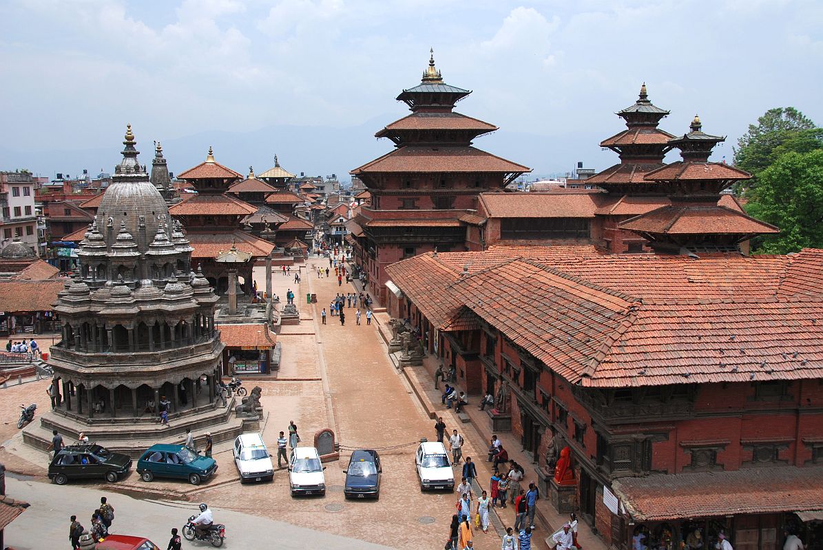 Kathmandu Patan Durbar Square 02 Krishna Temple, Taleju Bell, Hari Shankar Temple And Royal Palace The octagonal white stone Krishna Temple sits on the west side of Patans Durbar Square, while the whole eastern side is occupied by the Royal Palace. This view from the south was taken from the Teleju Restaurant.